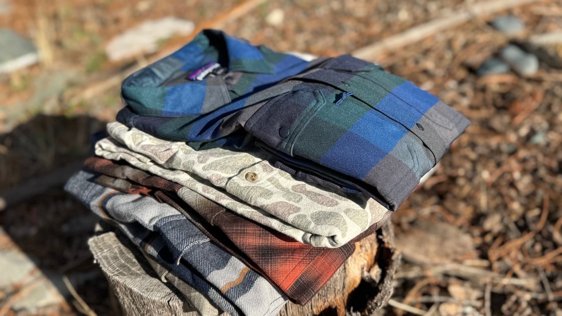 landscape-feature-of-the-best-performance-flannels-stacked-on-a-log