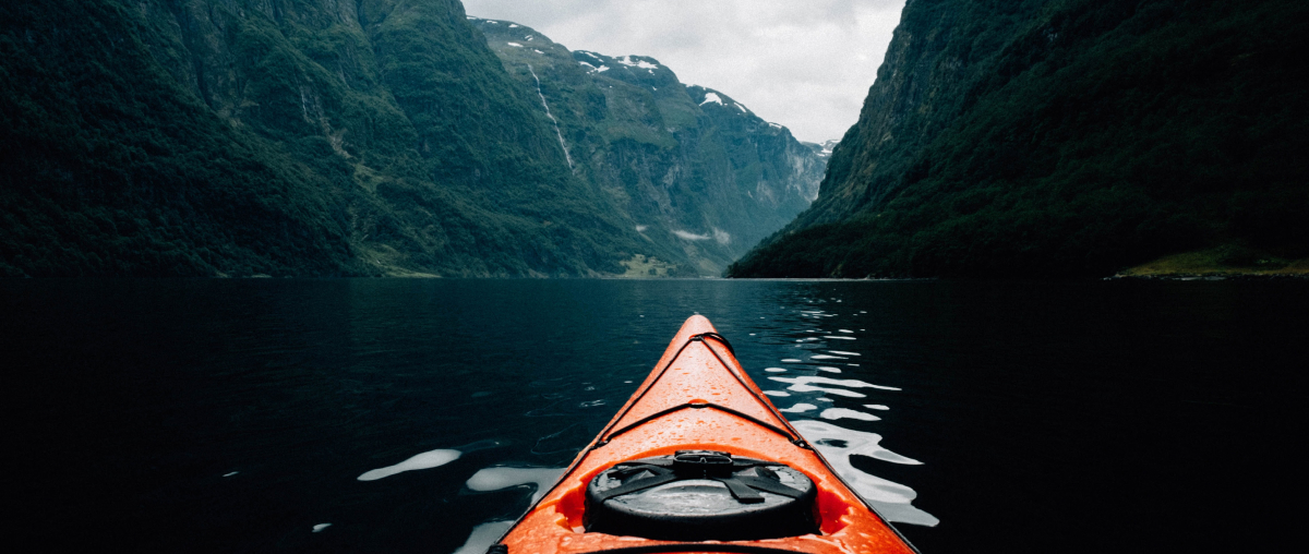 Image: a red kayak in a fjord